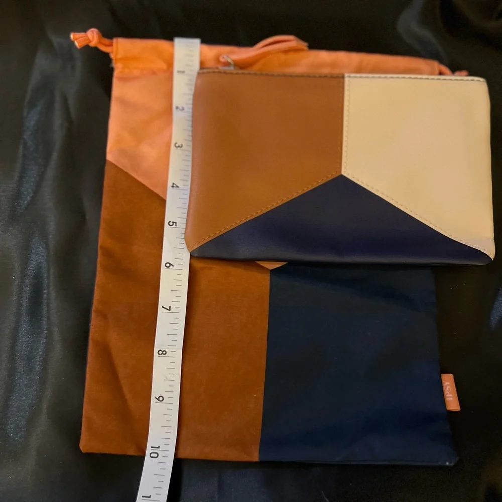 2 Ipsy bags, never used. One is a drawstring cloth bag and the other zips.